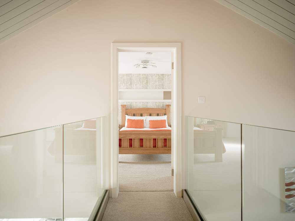 On the first floor there is a walkway with a glass balustrade between bedrooms 2 and 3.