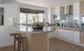 Pull up a pew and enjoy a glass of vino whilst watching the chef work their magic. - Thumbnail Image