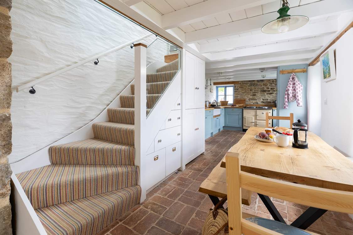 The stairs lead to the bedrooms and family shower-room.