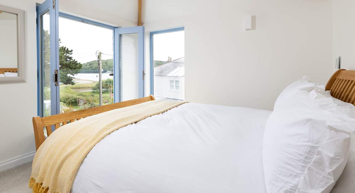 Upstairs the principal bedroom looks out over the creek and garden. 