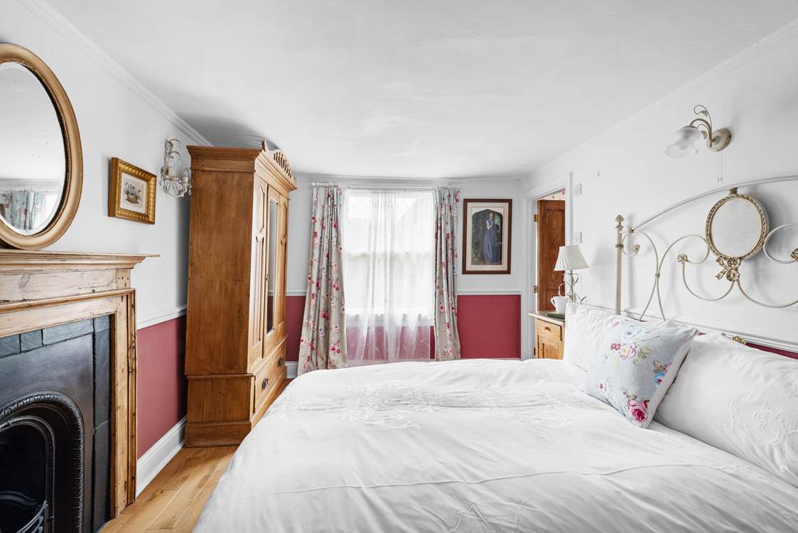Lovely linens and a beautiful ornamental fireplace.