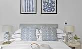 Snuggle under the covers of the comfy double bed. - Thumbnail Image