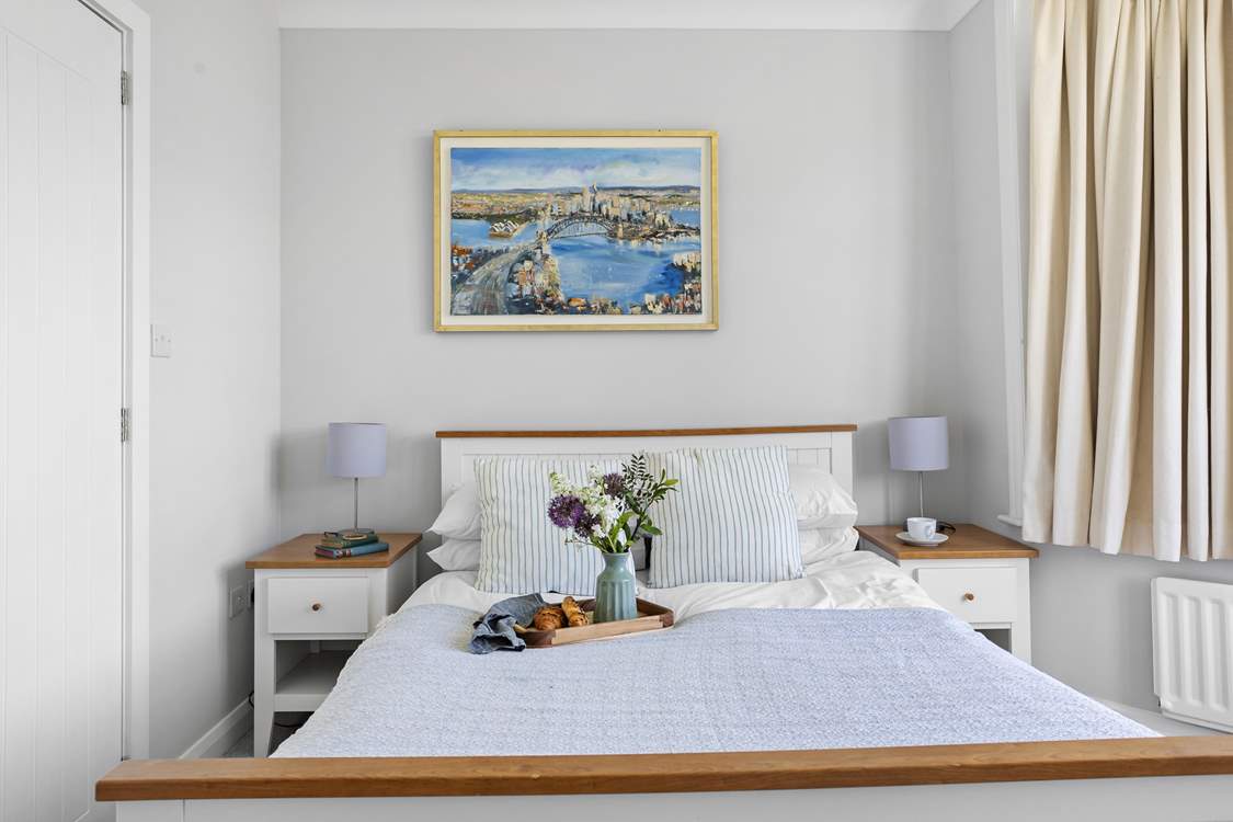 A double bed awaits in the wonderfully light and airy room.