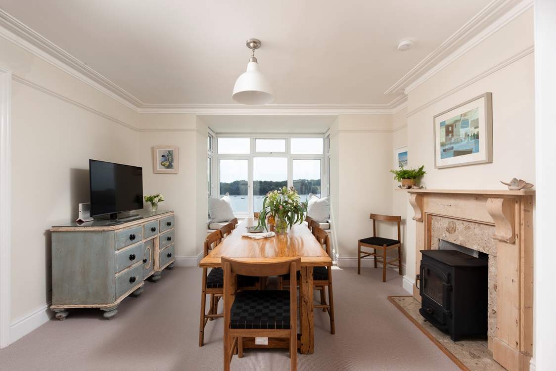 Gather everyone around the dining-table to plan the day ahead. (Ornamental fireplace only and wood-burner not for use)