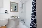 One of the bathrooms with bath and overhead shower.
