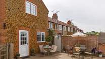 The sunny back garden is perfect for al fresco dining. 