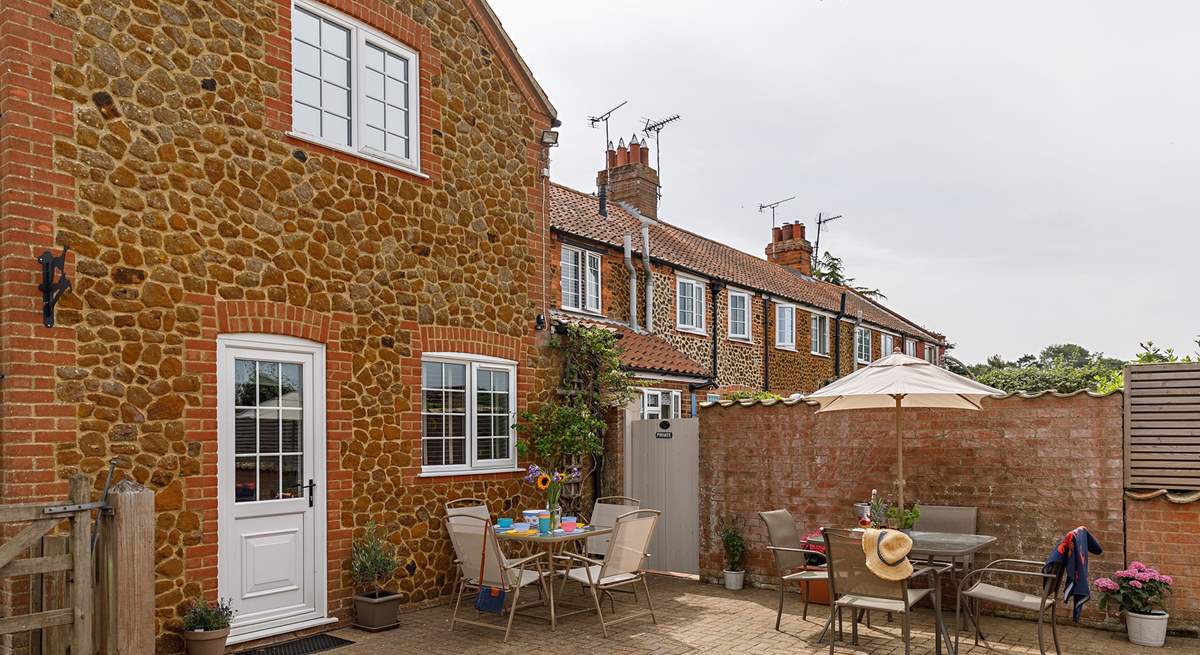 The sunny back garden is perfect for al fresco dining. 