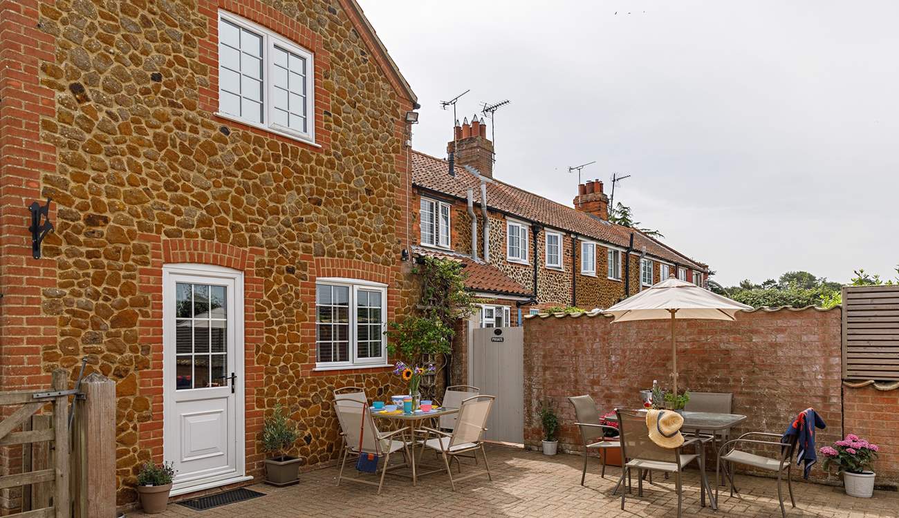 The sunny back garden is perfect for al fresco dining. 
