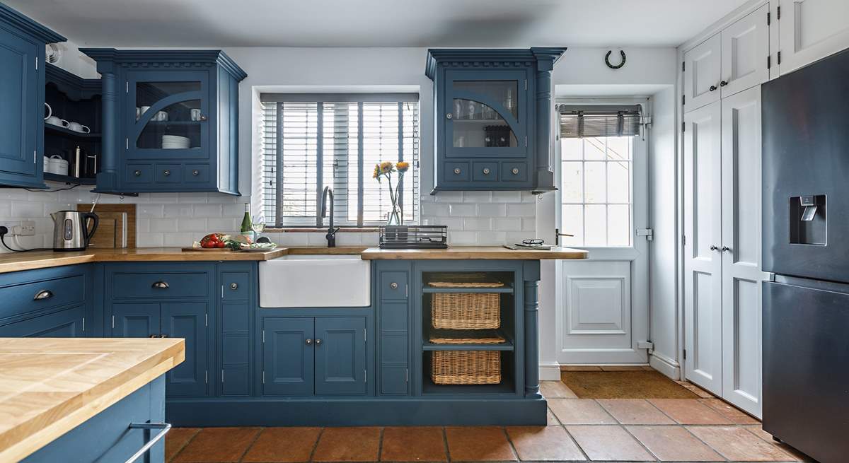 The stylish kitchen has all you need, and a washing machine and drier behind the doors next to the back door. 