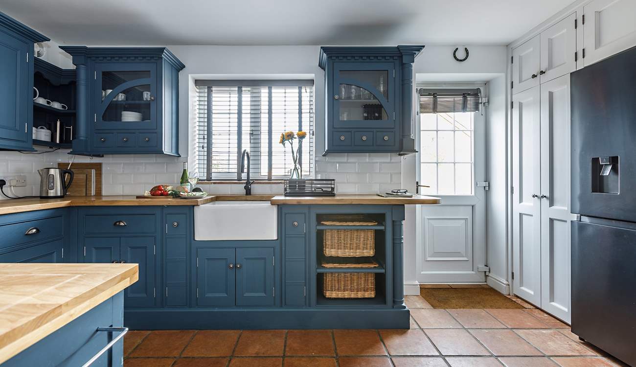 The stylish kitchen has all you need, and a washing machine and drier behind the doors next to the back door. 