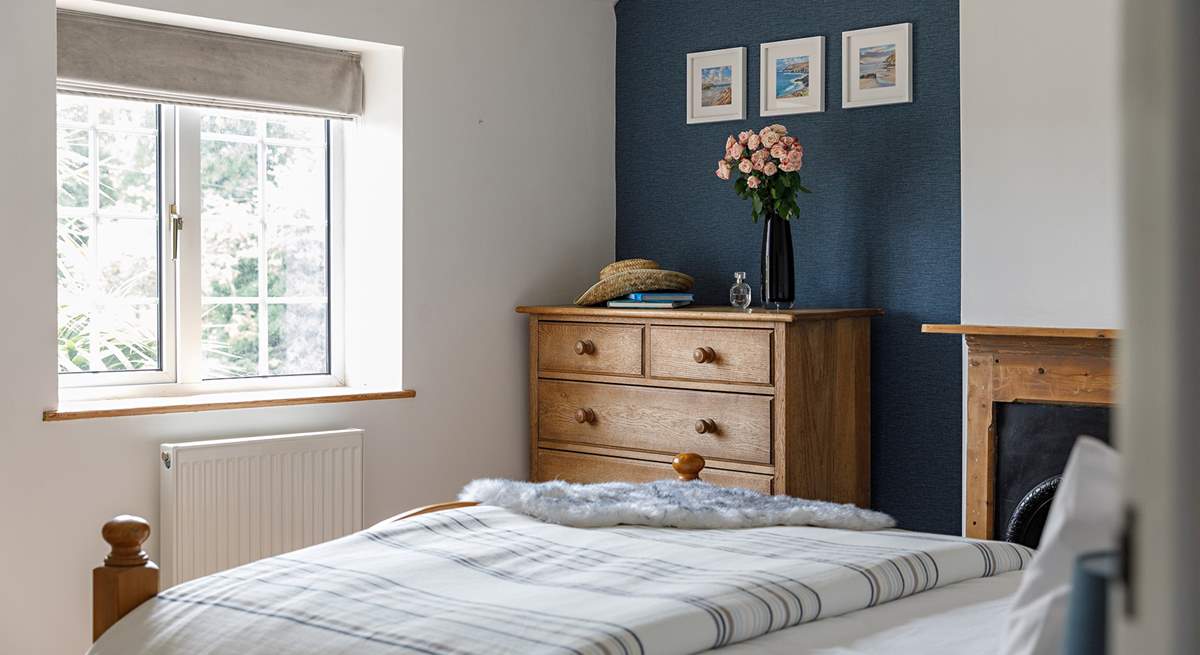The principal bedroom looks out onto the quiet lane to the front. 