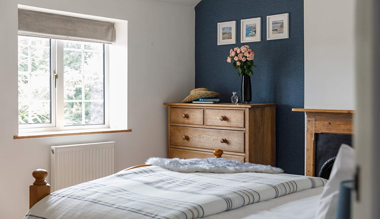 The principal bedroom looks out onto the quiet lane to the front. 