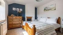 The gorgeous principal bedroom has a king-size bed for a restful night.
