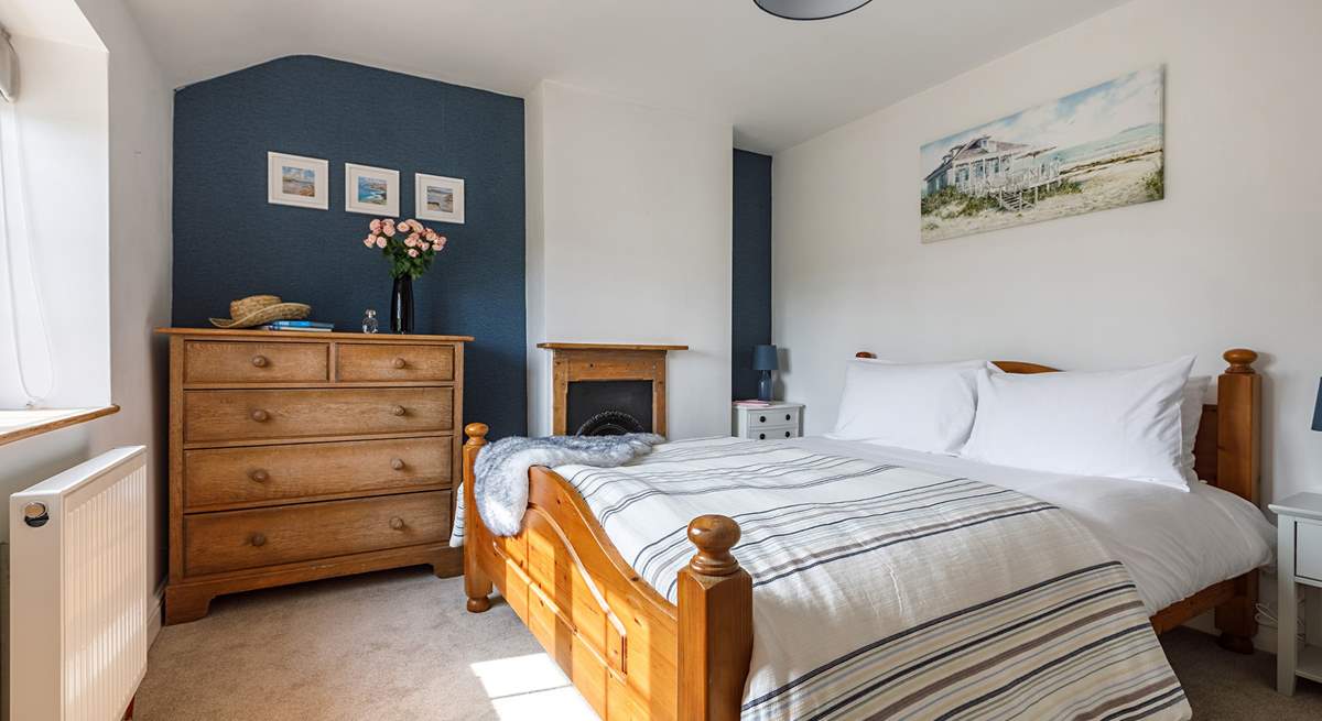 The gorgeous principal bedroom has a king-size bed for a restful night.