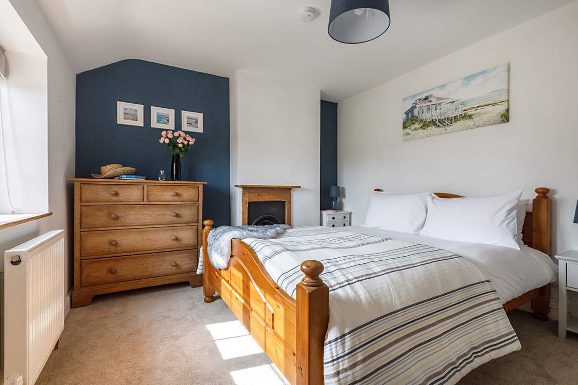 The gorgeous principal bedroom has a king-size bed for a restful night.