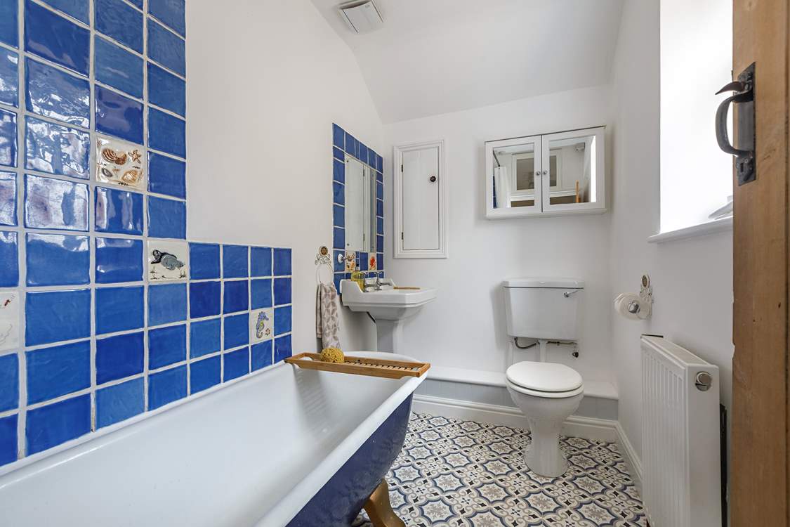 The family bathroom has a bath with a fitted shower.