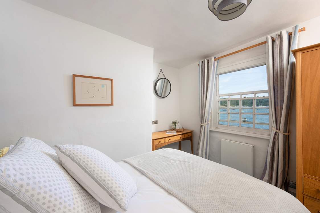 Spend enchanting hours watching the boats ply the waters around the harbour from the double bedroom.