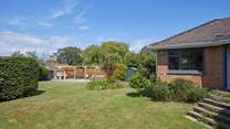 The enclosed rear garden offers a stunning outdoor retreat.