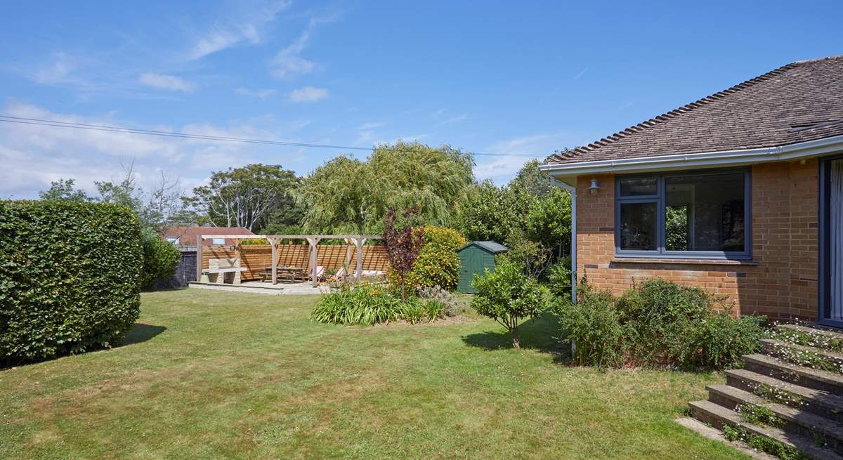 The enclosed rear garden offers a stunning outdoor retreat.