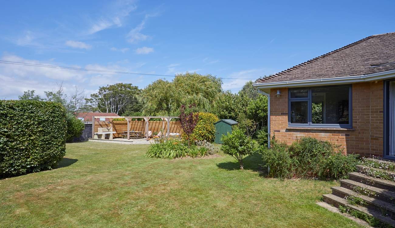The enclosed rear garden offers a stunning outdoor retreat.