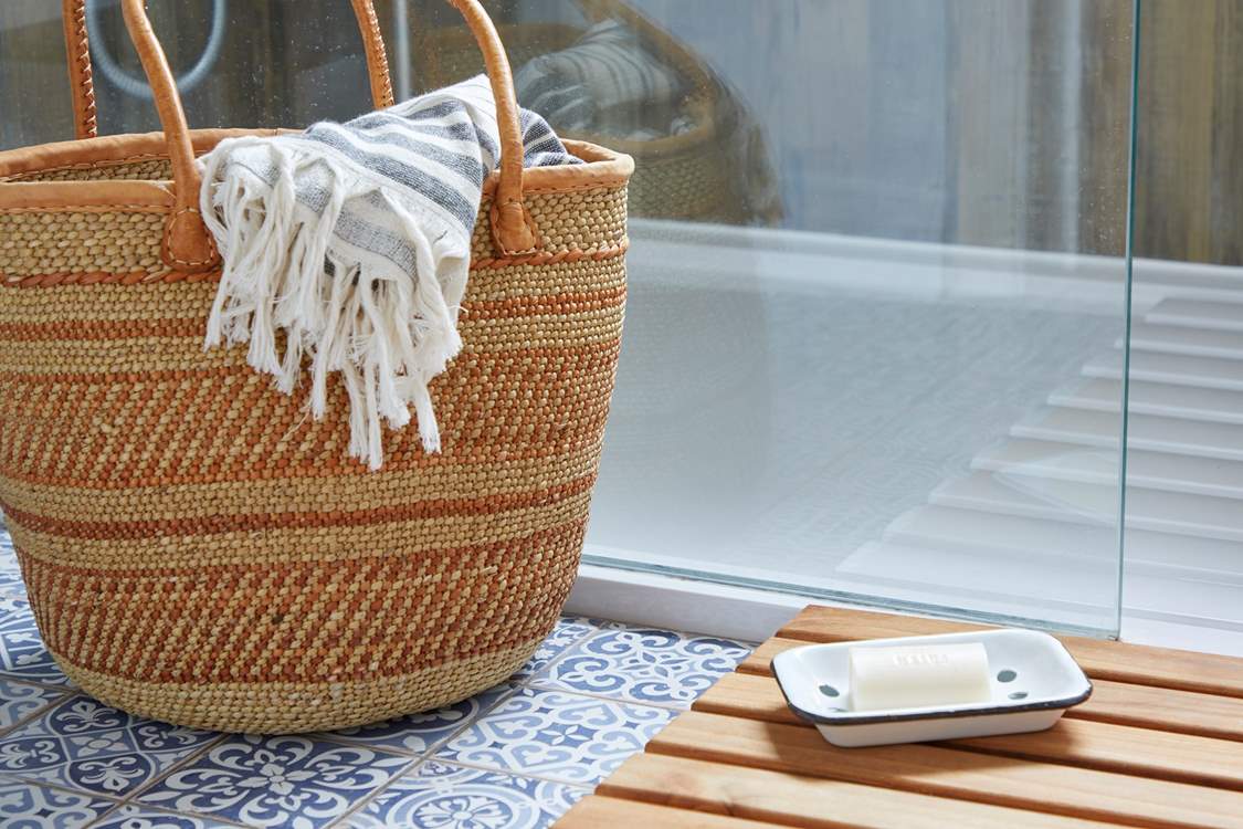 Step into the shower after a day at the nearby beach.