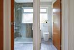 A stylish modern-rustic shower-room with a separate cloakroom next door. 