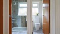 A stylish modern-rustic shower-room with a separate cloakroom next door. 
