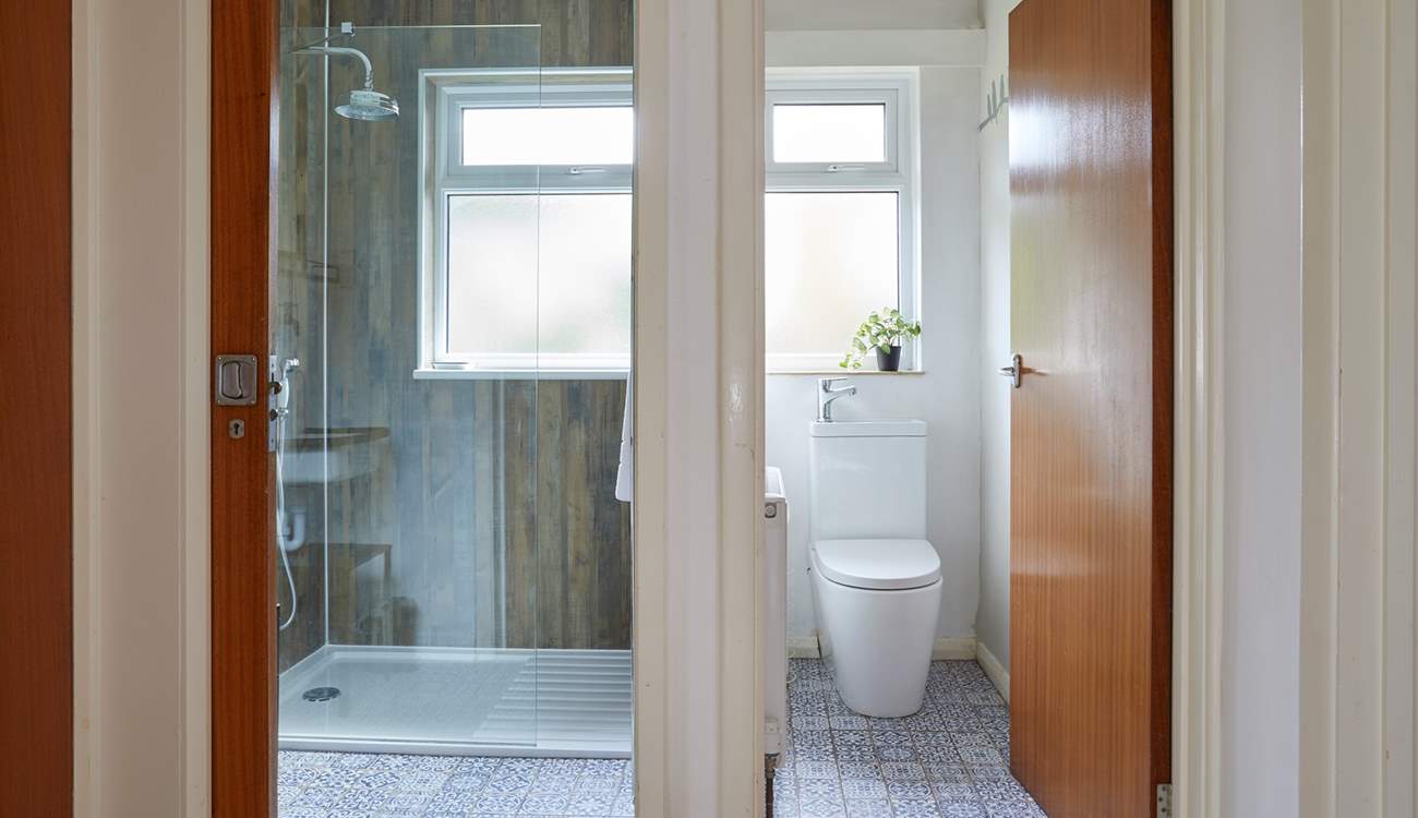 A stylish modern-rustic shower-room with a separate cloakroom next door. 