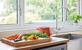 Prepare a meal in the kitchen while admiring the beautiful garden outlook. - Thumbnail Image