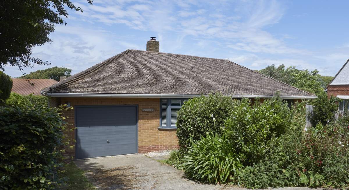 The driveway provides parking for up to two cars, and there is additional parking on the road. 