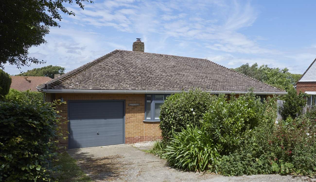 The driveway provides parking for up to two cars, and there is additional parking on the road. 