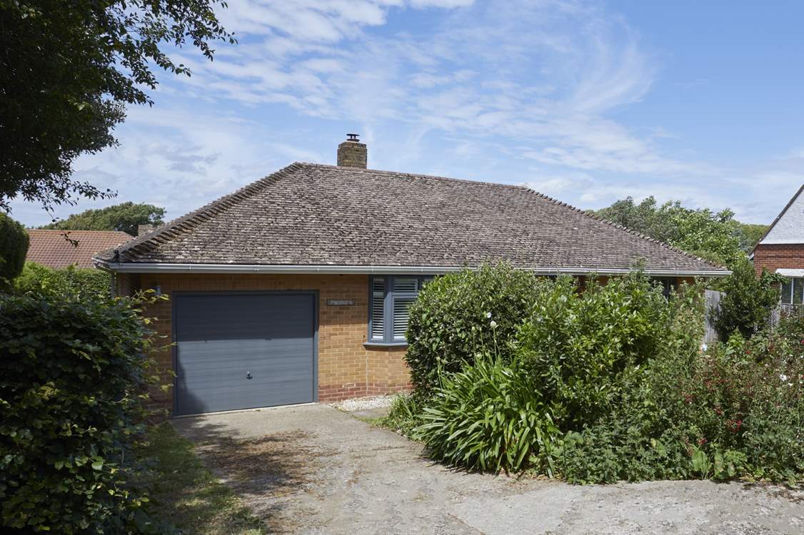 The driveway provides parking for up to two cars, and there is additional parking on the road.