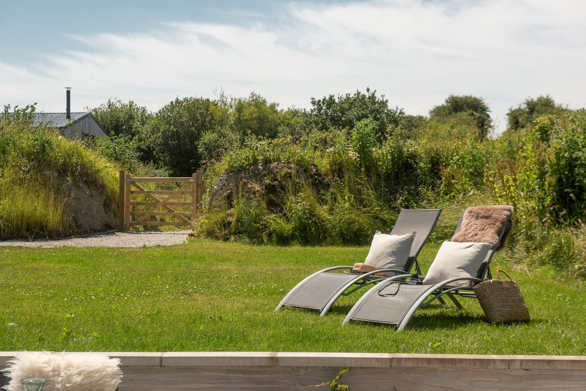 The sun-soaked garden is a haven for slow, al fresco living.