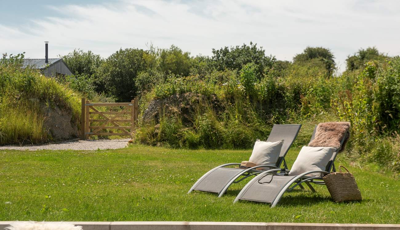 The sun-soaked garden is a haven for slow, al fresco living.