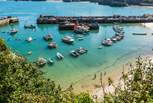 Visit Newquay for the bustling town and miles of sandy beaches.