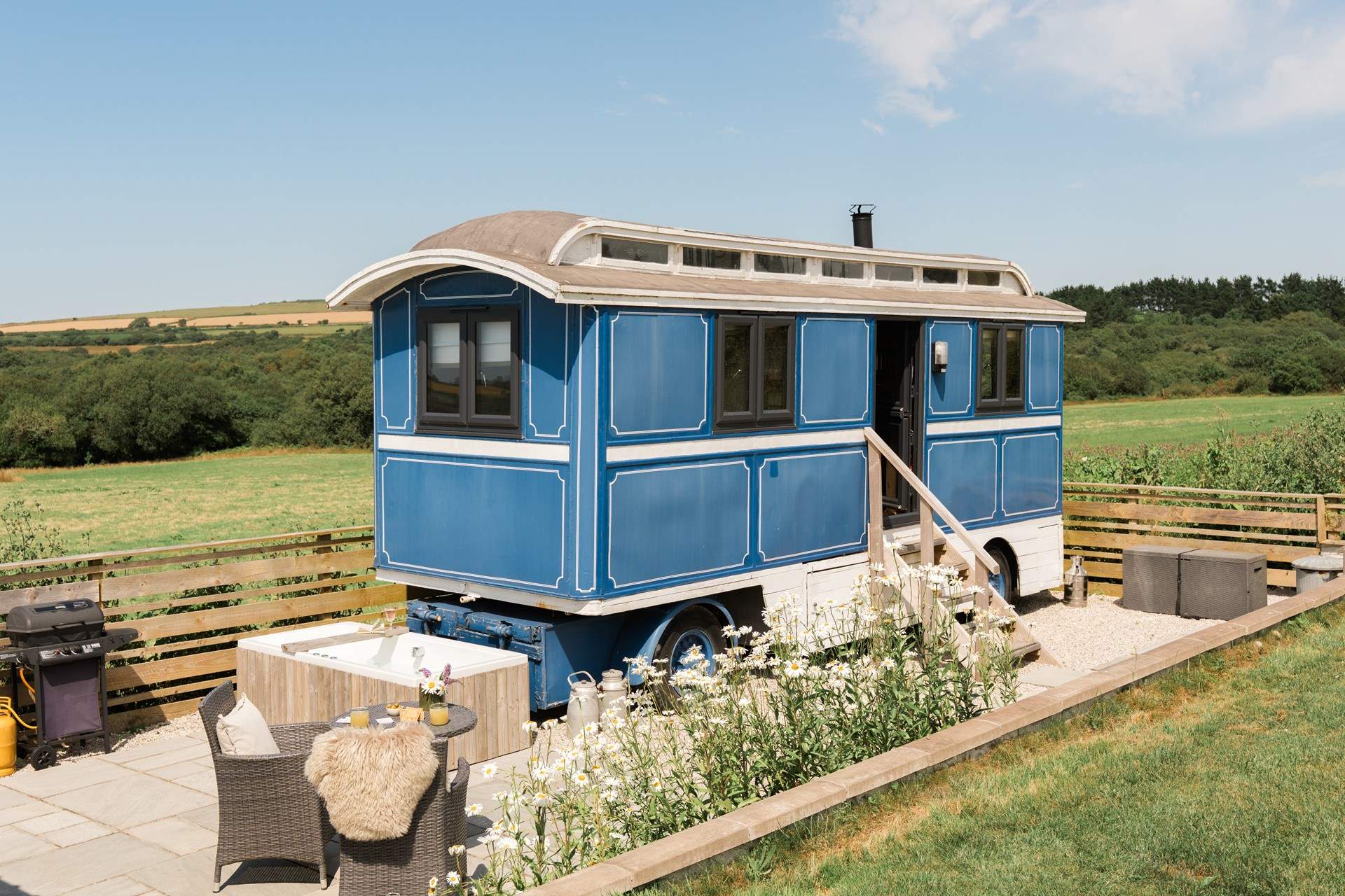 Bluebell - Showman’s wagon with an outdoor bath in Cornwall: Wrapped in rolling greenery and kissed by the Cornish sun, this one-of-a-kind hideaway promises a peaceful pause from the everyday. With a heavenly alfresco bath and enclosed garden, it’s perfect for whiling away leisurely afternoons, with plenty of space for your four-legged friend to roam. 