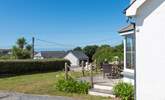 The front patio and garden is a lovely space for your loved ones to enjoy. - Thumbnail Image