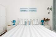 Bedroom 1 features an oceanic palette.