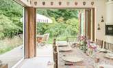 Bi-fold doors open to the deck-area and gorgeous garden. - Thumbnail Image