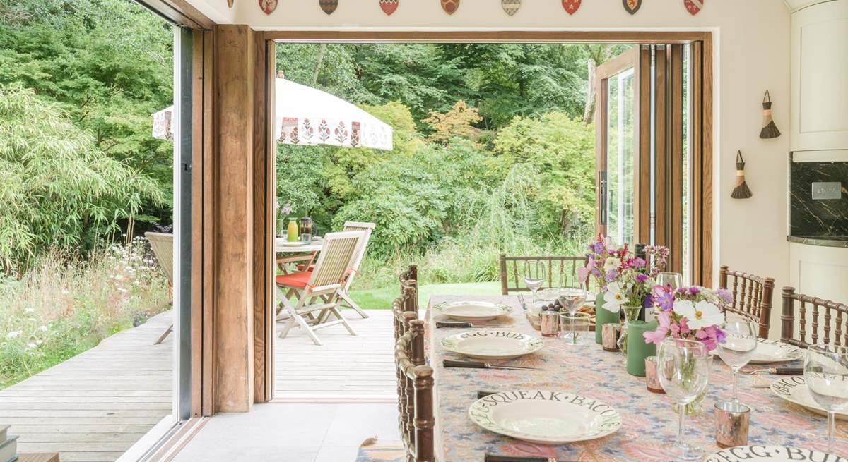 Bi-fold doors open to the deck-area and gorgeous garden.