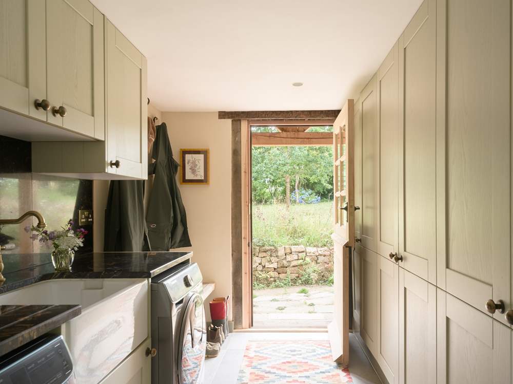 The utility-room with door that leads to the garden, where just outside you will find a useful shower to hose down muddy dogs and wellies.