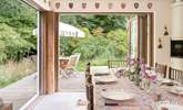 Bi-fold doors open to the deck-area and gorgeous garden. - Thumbnail Image