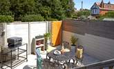 Step down from the decked terrace to the serene paved courtyard. - Thumbnail Image