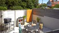 Step down from the decked terrace to the serene paved courtyard.