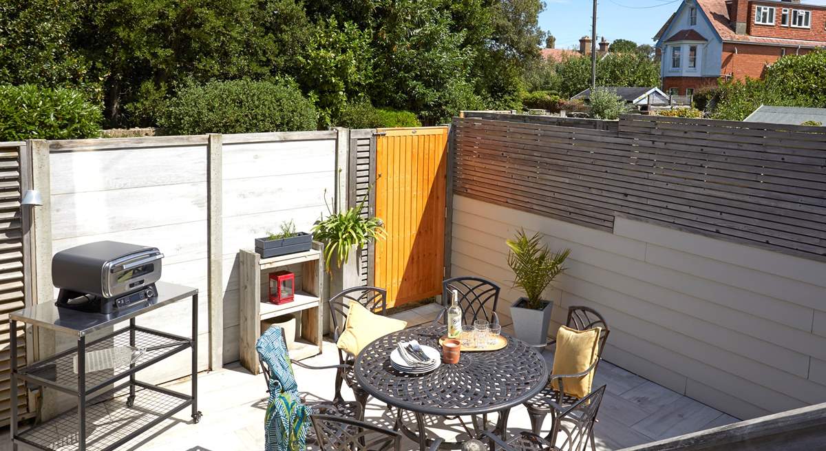 Step down from the decked terrace to the serene paved courtyard.