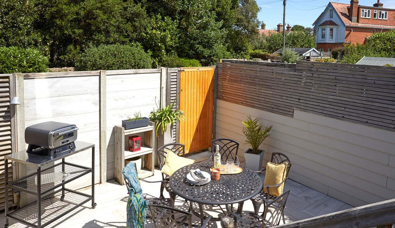 Step down from the decked terrace to the serene paved courtyard.