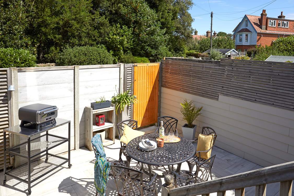 Step down from the decked terrace to the serene paved courtyard.