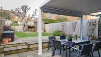 A fully enclosed garden is great for your four-legged friends, with shade under the apple tree.