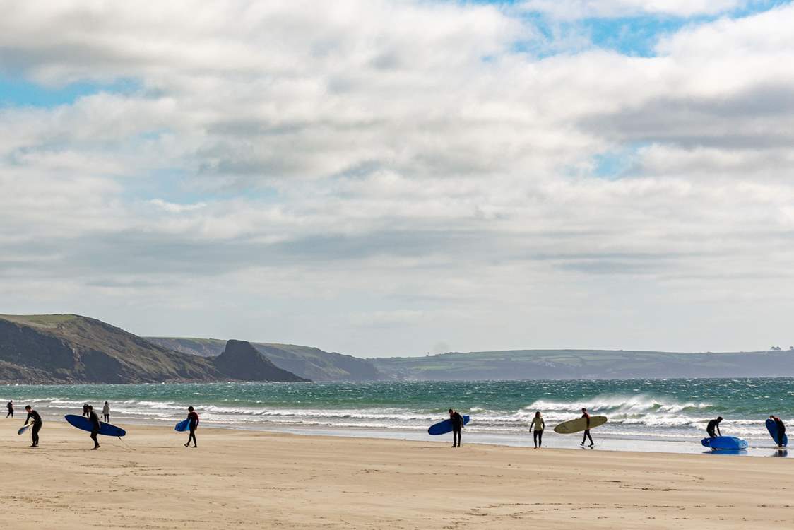 The golden sands and rolling surf at Newgale Beach are popular with surfers and families.