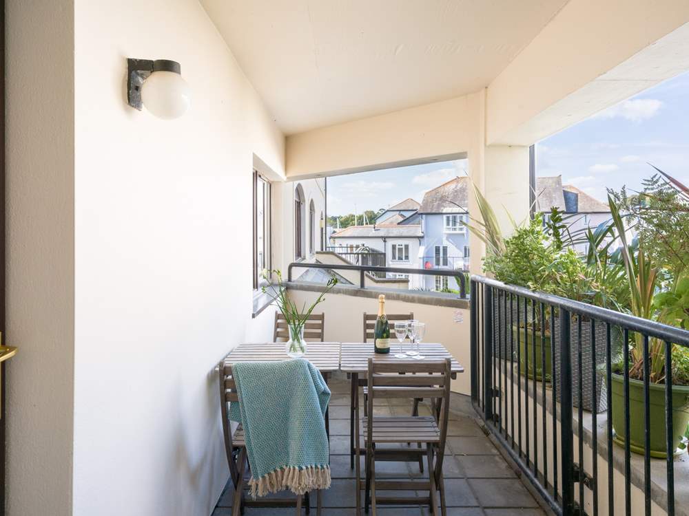 The little balcony is perfect for four relaxing at the end of the day, the neighbouring property's balcony adjoins hidden behind the foliage.